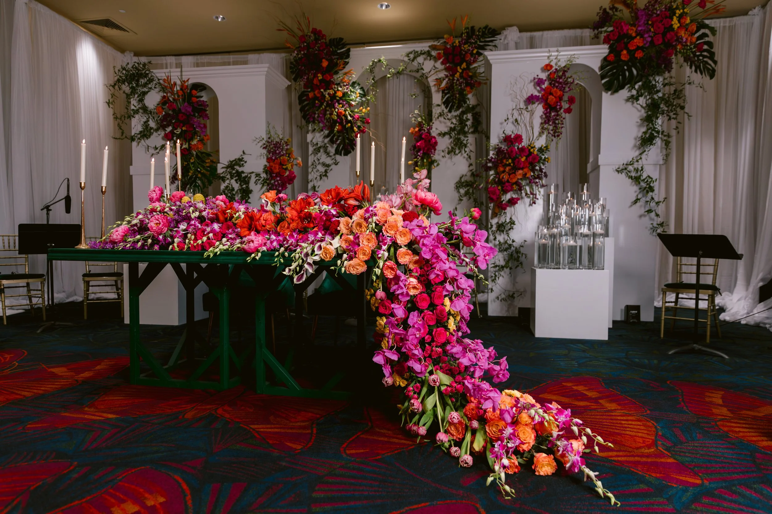 Vibrant floral installation and candles in an ELEVENTS event setting